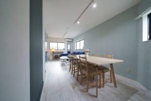 a dining room with a table and chairs at Airstar Hakata House in Fukuoka