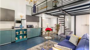 a kitchen and living room with blue cabinets at Luxury 2 bedroom Apartment with AC near Louvre in Paris