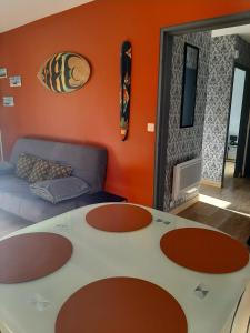 a living room with a table and a couch at CHARMANT APPARTEMENT CENTRE VILLE LE RONSARD in Nogent-le-Rotrou