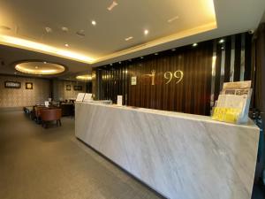 a lobby of a restaurant with a counter and chairs at IN99 Hotel in Jincheng