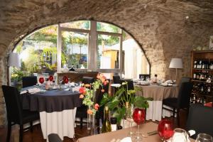 a dining room with two tables and a window at Il était 1 fois in Piolenc