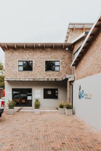 a brick building with a brick driveway in front of it at Execustay in Nelspruit