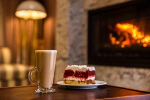 a piece of cake and a cup of coffee on a table at Sparkling Water Hotels & Spa in Rustenburg