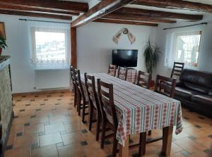 a dining room with a table and chairs and a television at Casa Maria in Vatra Dornei