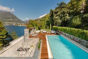 a beach with a pool and a balcony overlooking the ocean at Mandarin Oriental, Lago di Como in Blevio