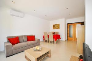 a living room with a couch and a table at Apartment Caracas 1 by Algarve Vacation in Albufeira