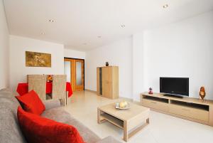 a living room with a couch and a tv at Apartment Caracas 1 by Algarve Vacation in Albufeira
