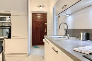 a kitchen with a sink and a wooden door at #J0 The sweet Jaurès in Grenoble +32 photos
