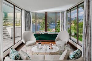 a living room filled with furniture and a window at Mandarin Oriental, Lago di Como in Blevio