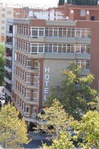 a tall building with a sign on the side of it at Pasarela in Seville