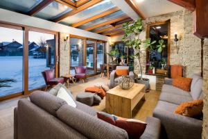 a living room with couches and a table at Alzbeta resort - Aqua & Wellness in Liptovský Mikuláš