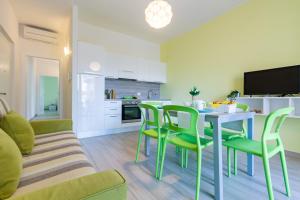 een keuken en een woonkamer met een tafel en stoelen bij Giada 2P - Palazzina Laura MyHo Casa in Tortoreto Lido