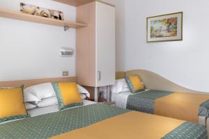 Postel nebo postele na pokoji v ubytování Hotel Principe