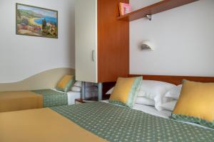 Postel nebo postele na pokoji v ubytování Hotel Principe