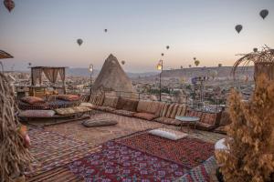 a view of a city with hot air balloons at Divan Cave House in Göreme