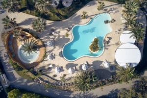 an overhead view of a pool at a resort at Ekies All Senses Resort, a Member of Design Hotels in Vourvourou