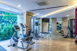 a gym with treadmills and elliptical machines at Pacific Park Hotel in Si Racha
