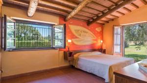 a bedroom with a bed and two windows at FONTE CANNELLA 12&4, Emma Villas in Manciano +31 photos