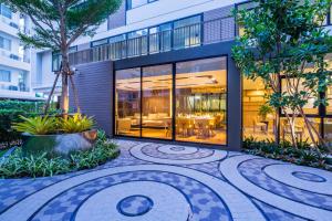 a building with a courtyard in front of it at Pacific Park Hotel in Si Racha