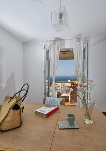 a table with a book and a cup on it at Apartments Ranieri Kono in Dubrovnik