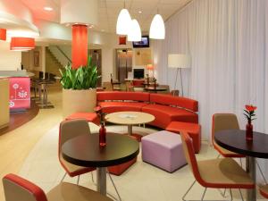 a living room filled with tables and chairs at Ibis Bratislava Centrum in Bratislava
