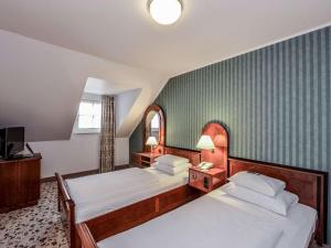Postel nebo postele na pokoji v ubytování Mercure Grand Hotel Biedermeier Wien