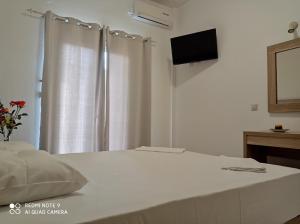Postel nebo postele na pokoji v ubytování KELLY APARTMENTS