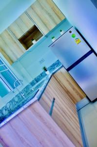 a room with a white refrigerator and wooden floors at The Nature House Aonang Krabi Thailand in Ao Nang Beach