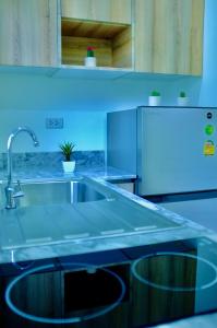 a blue kitchen with a sink and a refrigerator at The Nature House Aonang Krabi Thailand in Ao Nang Beach