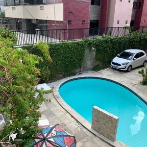a car parked next to a swimming pool at Manaira Hostel in João Pessoa