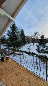 an outdoor deck with snow on the ground at Bran 99 in Bran