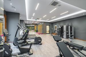 a gym with treadmills and elliptical machines at Apartment Antonio in Gdańsk