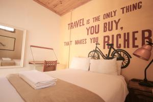 1 dormitorio con 1 cama con una bicicleta en la pared en CURIOCITY Backpackers Johannesburg, en Johannesburgo