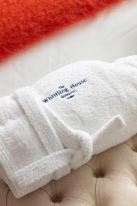 a white sweater with the words warming up knows hate on it at The Whittling House in Alnmouth