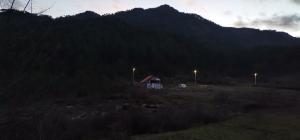 a house in the middle of a mountain with lights at Trebinje - Vikendica Vukovic in Trebinje