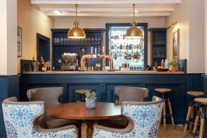 a bar with a wooden table and chairs at The Whittling House in Alnmouth +33 photos