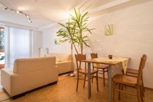 a living room with a table and a plant at Ferienwohnung im alten Forsthaus in Bermatingen