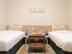 A bed or beds in a room at See U Tainan Apartment