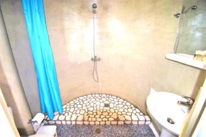 a small bathroom with a shower with a toilet at New Paradise in Mikonos