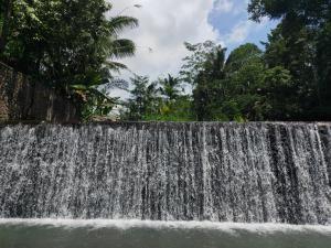 a waterfall on the side of a river at Astana Swaha Villa in Sidemen