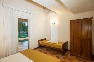 Postel nebo postele na pokoji v ubytování Borgo San Antonio & Borgo San Giuseppe by La Principina