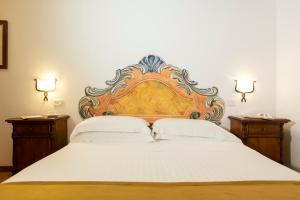Postel nebo postele na pokoji v ubytování Borgo San Antonio & Borgo San Giuseppe by La Principina