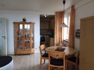 cocina y comedor con mesa y sillas en Haus Uthlande Uthlande Whg 5 Seepferdchen en Wyk auf Föhr