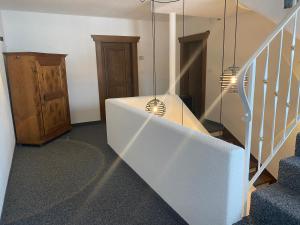 a room with a staircase with blue carpeted floors and a stair case at Haus Schönblick in San Lorenzo di Sebato