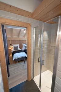 a room with a shower and a bedroom at Appartements Chalet Le Fornay in Morzine