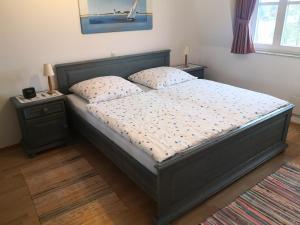 a bedroom with a large bed with two night stands at Das Landhaus am Haff LHH A04 in Stolpe +3 photos