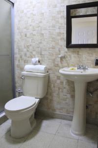 a bathroom with a toilet and a sink at Hotel Doral in Panama City