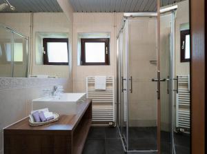 a bathroom with a sink and a shower at Hotel Flores in Poreč +37 photos