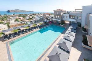 an overhead view of a swimming pool with umbrellas at Caldera Village in Agia Marina Nea Kydonias