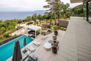 an aerial view of a house with a swimming pool at Stunning Kvarner Villa 5 Bedrooms Villa Aura Caesar Stunning Sea Views & Private Pool Opatija in Medveja